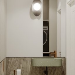 Como Studio Karolina Sawala - Minimalistyczna łazienka w neutralnych barwach: podwieszana toaleta, umywalka w odcieniu zieleni, marmurowe wykończenie ścian i podłogi, owalna lampa ścienna.