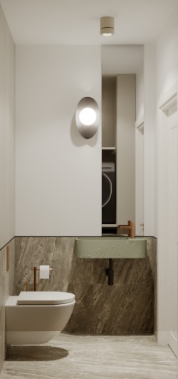 Minimalistyczna łazienka w neutralnych barwach: podwieszana toaleta, umywalka w odcieniu zieleni, marmurowe wykończenie ścian i podłogi, owalna lampa ścienna.