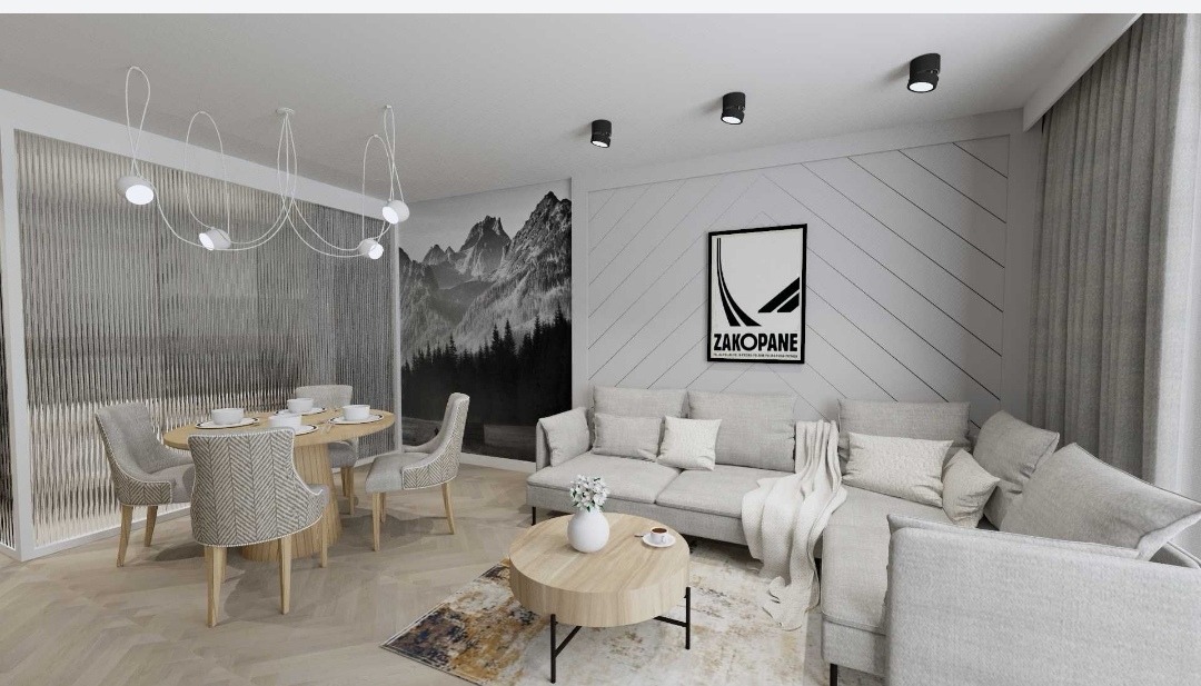 Jasne wnętrze z jadalnią i salonem w stylu skandynawskim. Minimalistyczny design, drewniane akcenty i grafika z motywem Zakopanego.