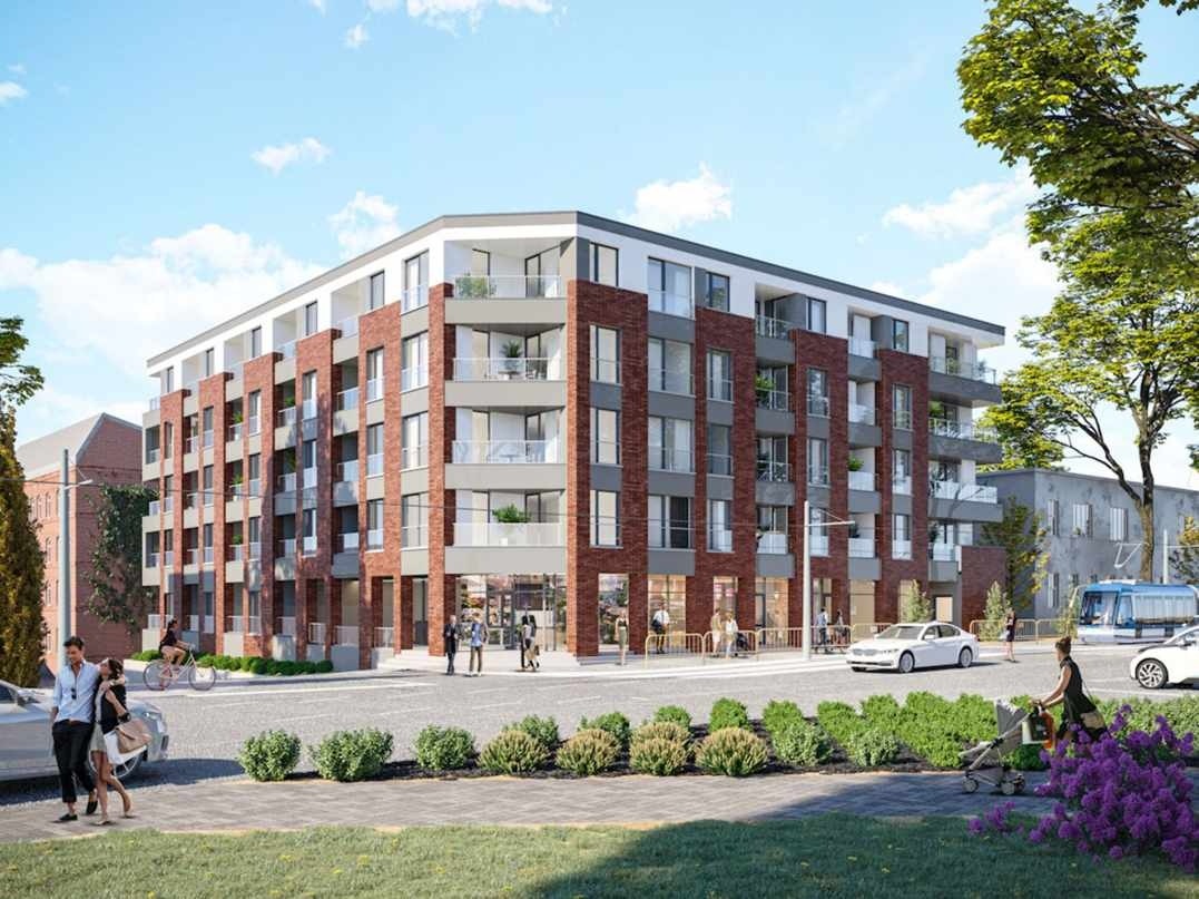 Wizualizacja nowoczesnego, wielopiętrowego budynku mieszkalnego z ceglaną elewacją i balkonami, otoczonego zielenią i przechodniami w słoneczny dzień.