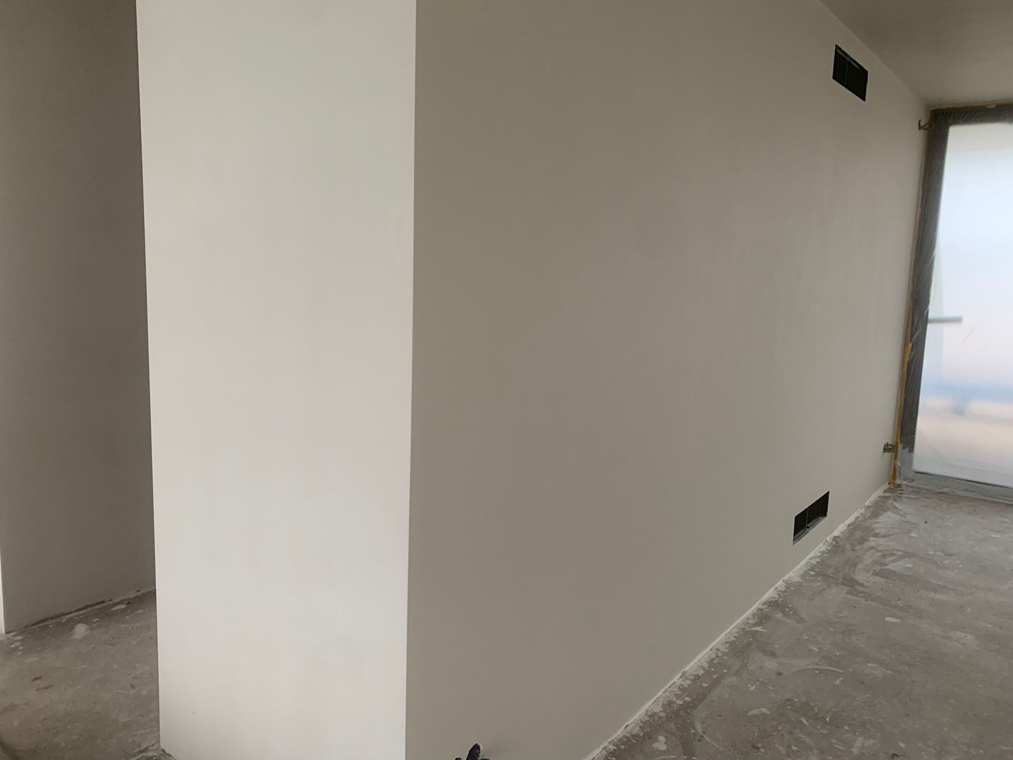 Ściana po obróbce w Ząbkach: gładka powierzchnia z widocznymi otworami wentylacyjnymi, przygotowana do dalszych prac wykończeniowych. Minimalistyczny kadr.