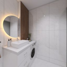 ARBUD TOMASZ PUŃKO - Nowoczesna łazienka z białymi płytkami imitującymi marmur, okrągłym lustrem z podświetleniem LED i drewnianą ścianką. Umywalka nablatowa i pralka w zabudowie.