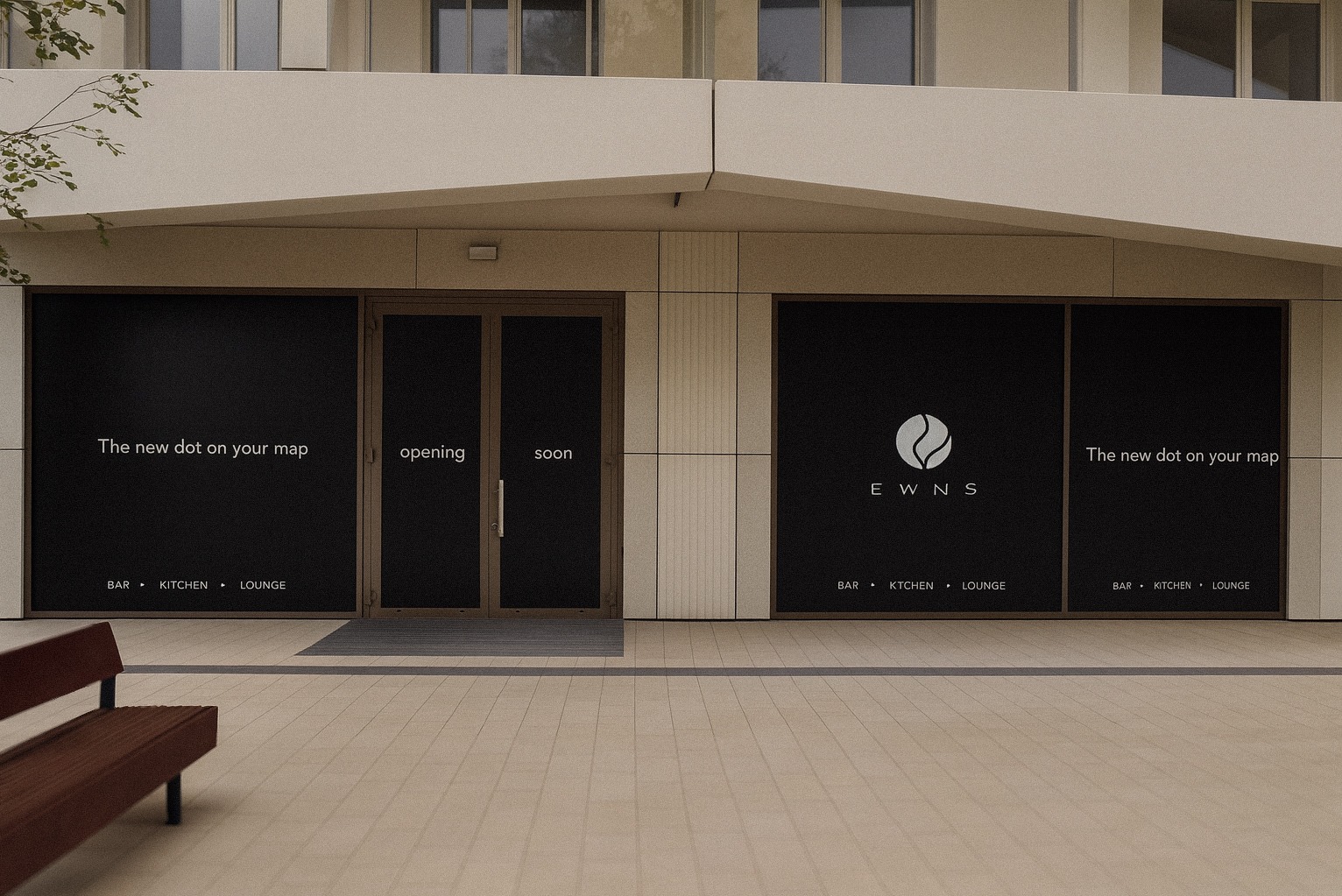 Elewacja budynku z czarnymi panelami reklamowymi 'EWNS' i hasłem 'The new dot on your map', zapowiadającymi otwarcie baru, kuchni i lounge.