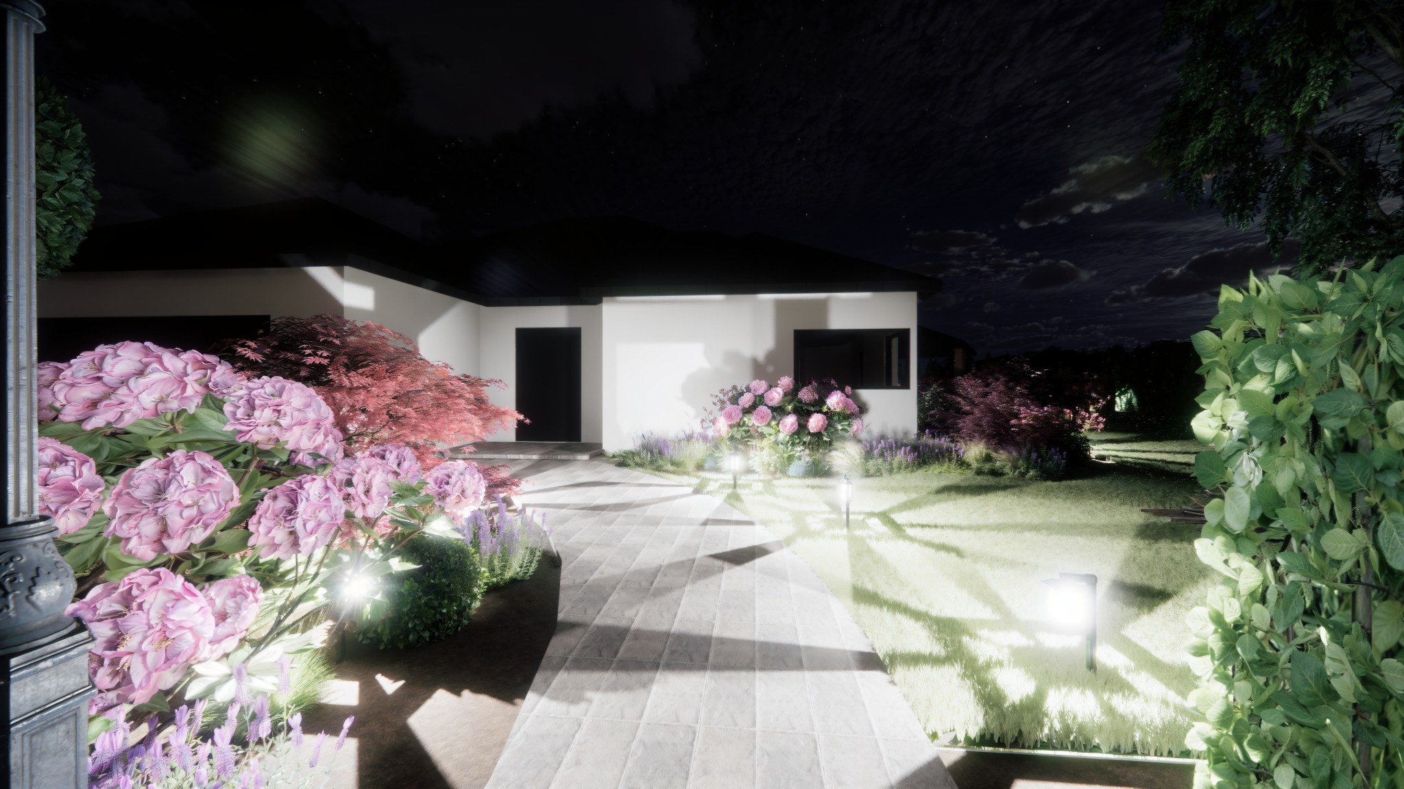 Oświetlony nocą ogród z kwitnącymi hortensjami i ścieżką z płyt, prowadzącą do nowoczesnego domu z czarnym dachem. Dekoracyjne lampy ogrodowe podkreślają roślinność.