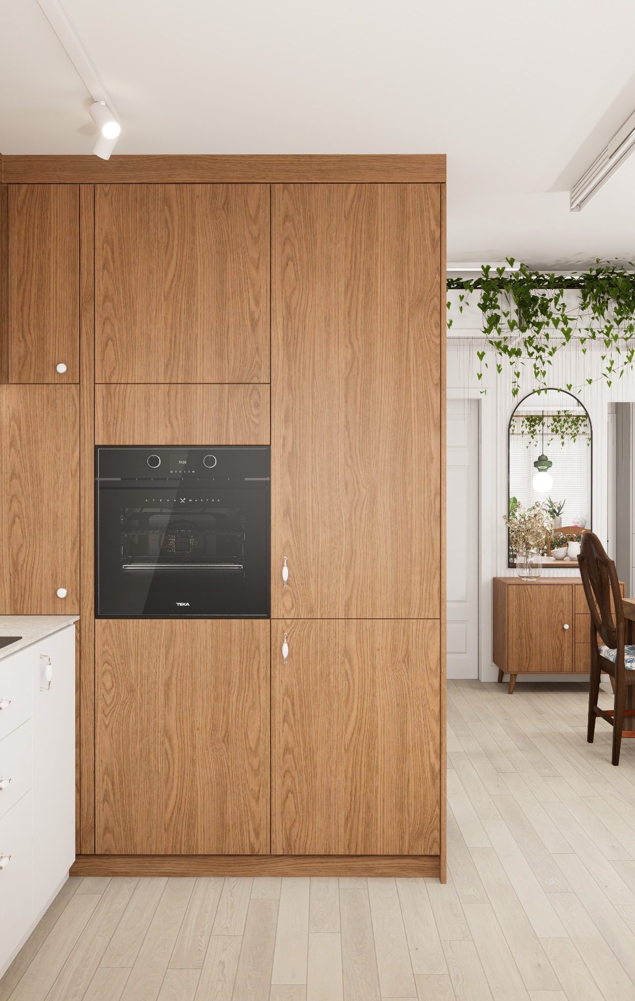 Drewniana zabudowa kuchenna z piekarnikiem TEKA, białe szafki, drewniana podłoga i dekoracje roślinne w tle. Minimalistyczny design.