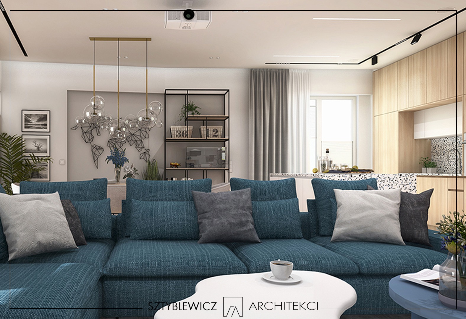 Salon z turkusową sofą modułową, stolikiem kawowym i dekoracyjną lampą. W tle regał, mapa świata na ścianie i drewniana zabudowa kuchenna. Widoczny projektor na suficie.