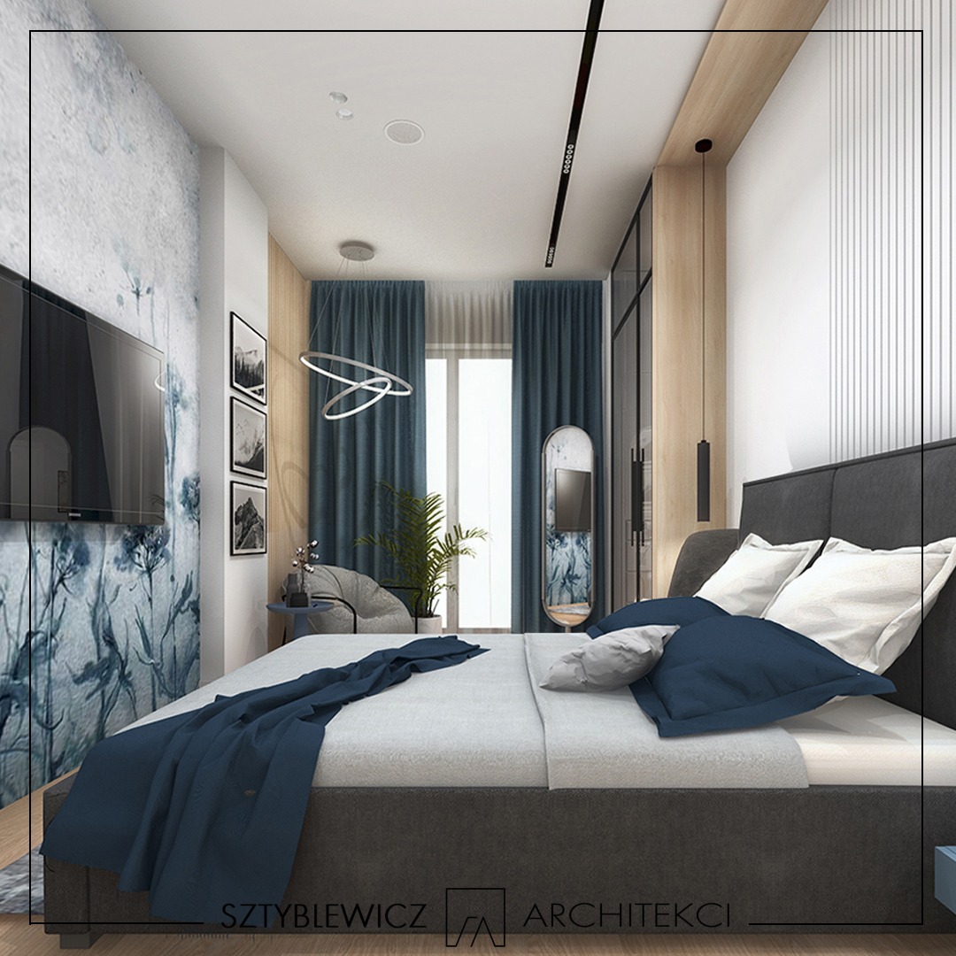 Wizualizacja sypialni z łóżkiem, tapetą w kwiaty i zasłonami w odcieniach niebieskiego. Nowoczesne oświetlenie i lustro dodają elegancji. Projekt Szyblewicz Architekci.