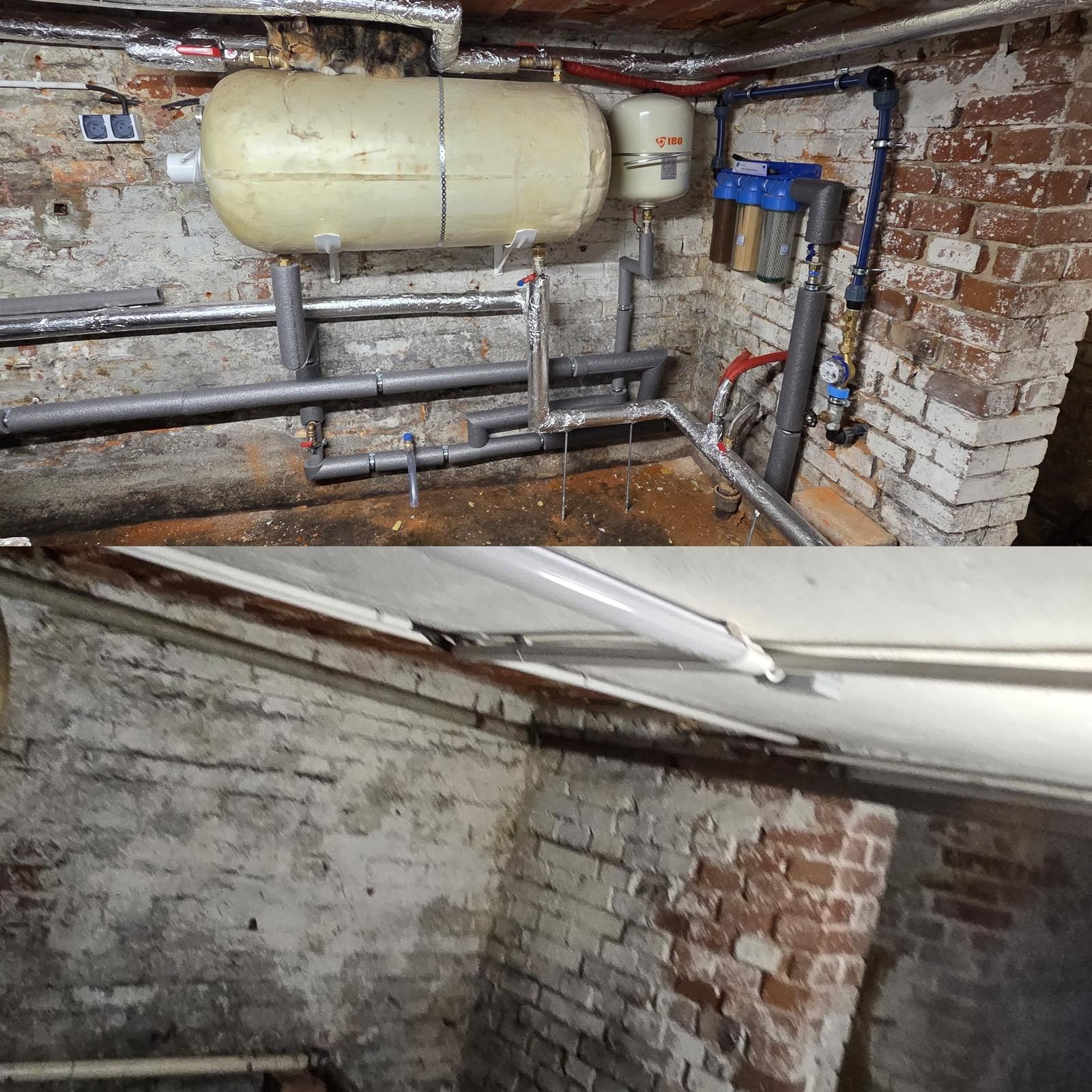 Instalacja grzewcza w piwnicy z kotłem, zbiornikiem wyrównawczym IBO i filtrami wody, rury w izolacji termicznej, ściany z cegły. Kot na zbiorniku.