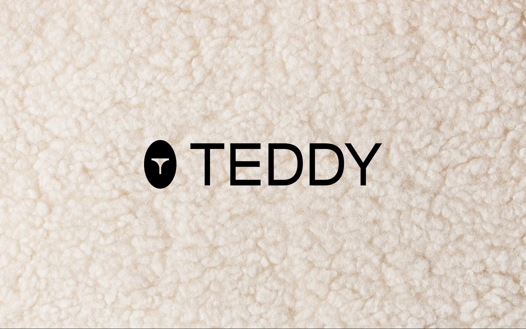 Minimalistyczne logo 'TEDDY' w czerni, z symbolem w kształcie litery T w okręgu, na tle kremowej, teksturowanej tkaniny przypominającej wełnę.