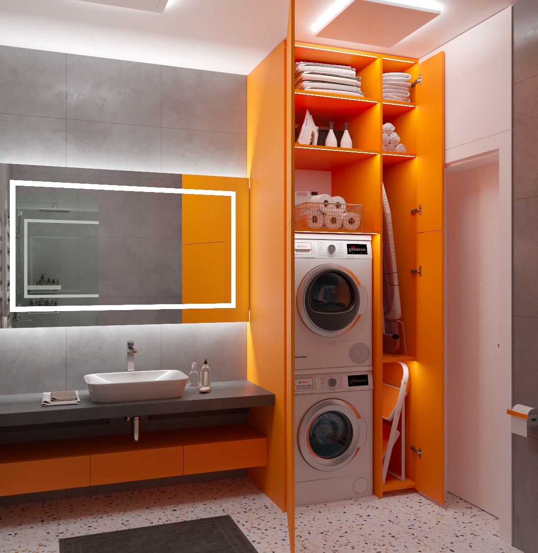 Nowoczesna łazienka z pomarańczowymi akcentami: szafka z pralką i suszarką, podświetlane lustro, szara ściana i wzorzysta podłoga. Minimalistyczny design.