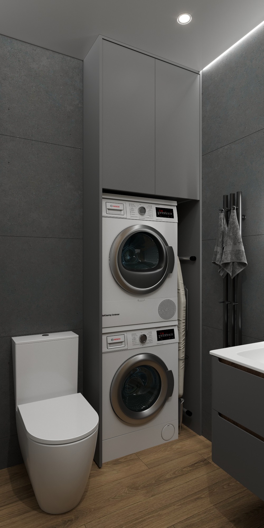 Nowoczesna łazienka w szarościach z pralką i suszarką w zabudowie, drewnopodobna podłoga, minimalistyczna armatura i teksturowane ściany.