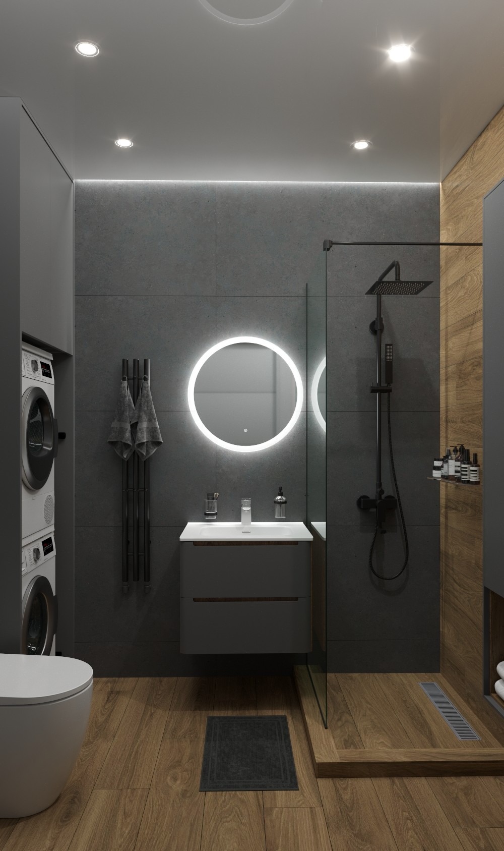 Nowoczesna łazienka z szarą armaturą, okrągłym lustrem z podświetleniem LED, drewnianą podłogą i kabiną prysznicową typu walk-in. Pralka i suszarka w zabudowie.