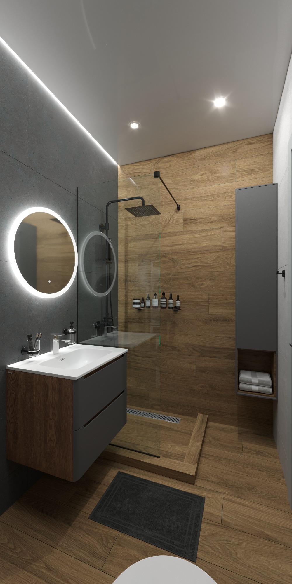 Nowoczesna łazienka z drewnianymi akcentami: kabina prysznicowa ze szklaną ścianą, okrągłe lustro z podświetleniem LED i szafka umywalkowa w odcieniach szarości.