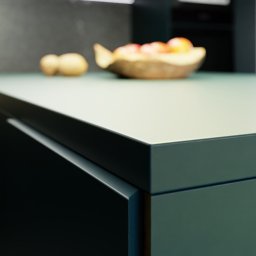 P2Studio Mateusz Grzesik - Detale wykończenia blatu kuchennego w odcieniach zieleni i szarości, z owocami w tle. Minimalistyczny design, gładkie powierzchnie, nowoczesne oświetlenie.