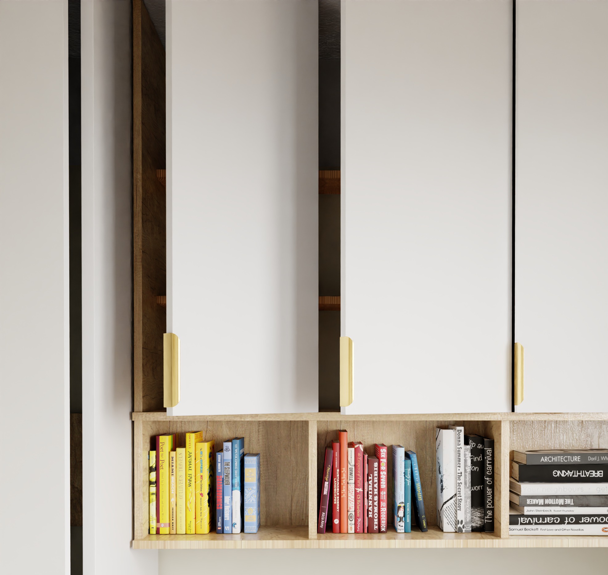 Regał z książkami pod białymi szafkami wiszącymi z złotymi uchwytami. Widoczne różne tytuły książek, tworzące domową biblioteczkę. Element wystroju wnętrza.