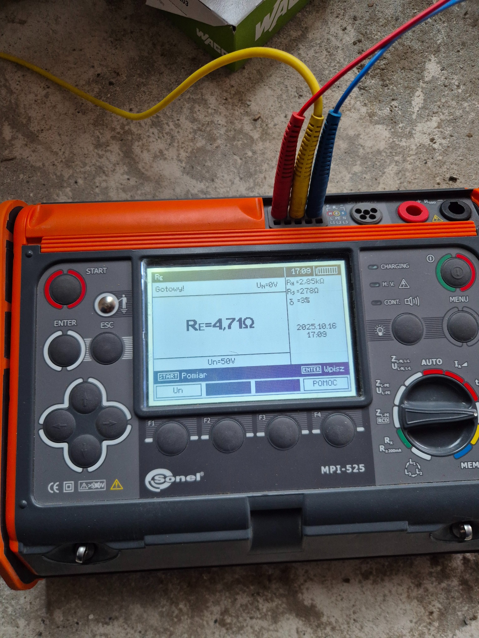 Miernik Sonel MPI-525 z podłączonymi przewodami pomiarowymi, wyświetlający wynik pomiaru rezystancji uziemienia Re=4,71Ω. Widoczne menu i przyciski urządzenia.