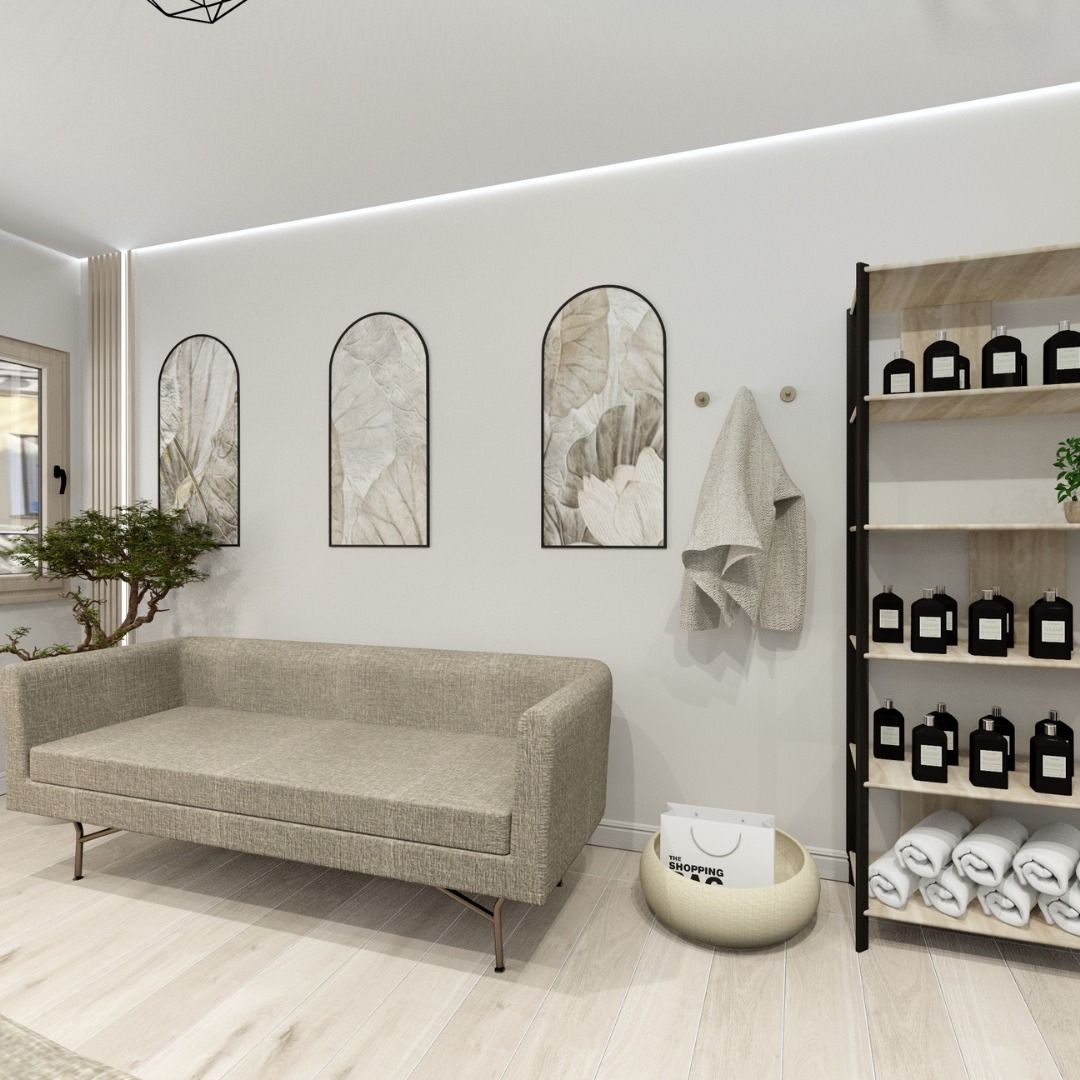 Jasna sofa z minimalistycznymi obrazami w łukowych ramach i regał z kosmetykami, tworzące spójną aranżację wnętrza w neutralnej kolorystyce.