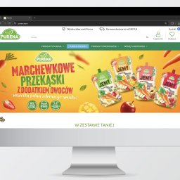 Pin Media Marcin Bąk - Monitor wyświetla stronę internetową Purena z marchewkowymi przekąskami w saszetkach. Żywe kolory i apetyczne owoce zachęcają do zakupu. Promocja 'W zestawie taniej'.