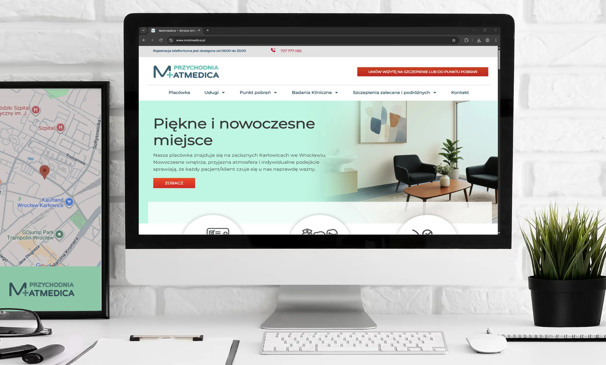 Ekran komputera prezentuje stronę internetową przychodni +Atmedica. Obok ramka z mapą lokalizacji. Minimalistyczne biurko z klawiaturą i rośliną doniczkową.