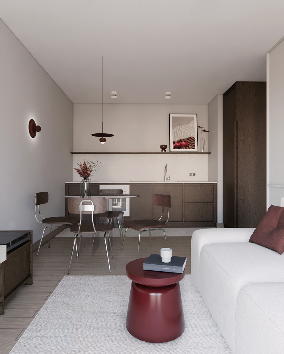 Wnętrze mieszkania w neutralnych barwach z akcentami bordo: stół z krzesłami, sofa, stolik kawowy, zabudowa kuchenna. Minimalistyczny design, oświetlenie punktowe.