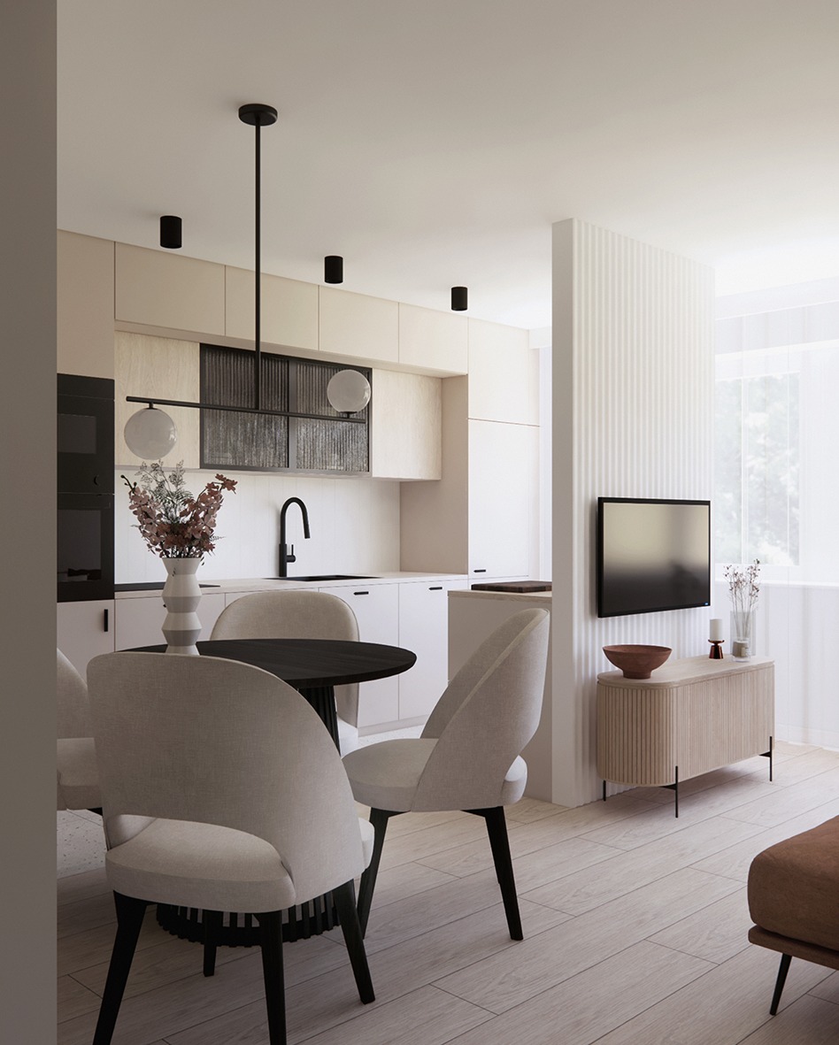 Jasne wnętrze: kuchnia z jadalnią w neutralnych barwach. Okrągły stół z krzesłami, minimalistyczna zabudowa kuchenna, telewizor na ścianie z lamelami. Nowoczesny design.