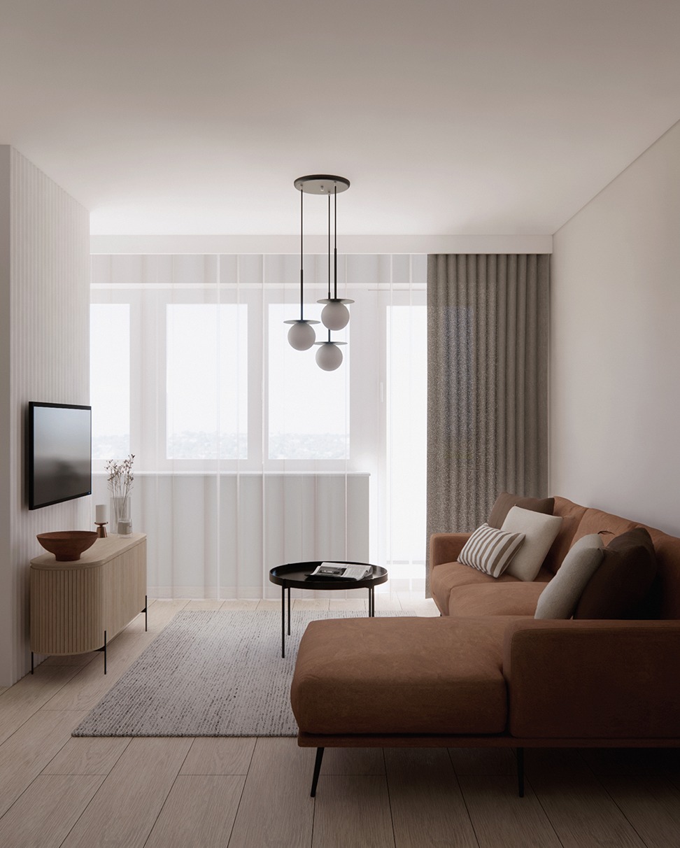 Jasne wnętrze salonu z brązową sofą narożną, stolikiem kawowym i komodą pod telewizorem. Minimalistyczny design, naturalne światło wpadające przez okno.