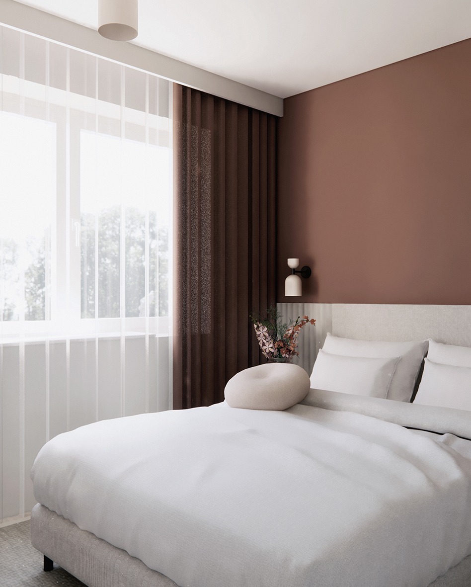 Jasna sypialnia z dużym oknem, brązowymi zasłonami i dekoracyjną lampą ścienną. Minimalistyczny styl, biała pościel i okrągła poduszka dodają przytulności.