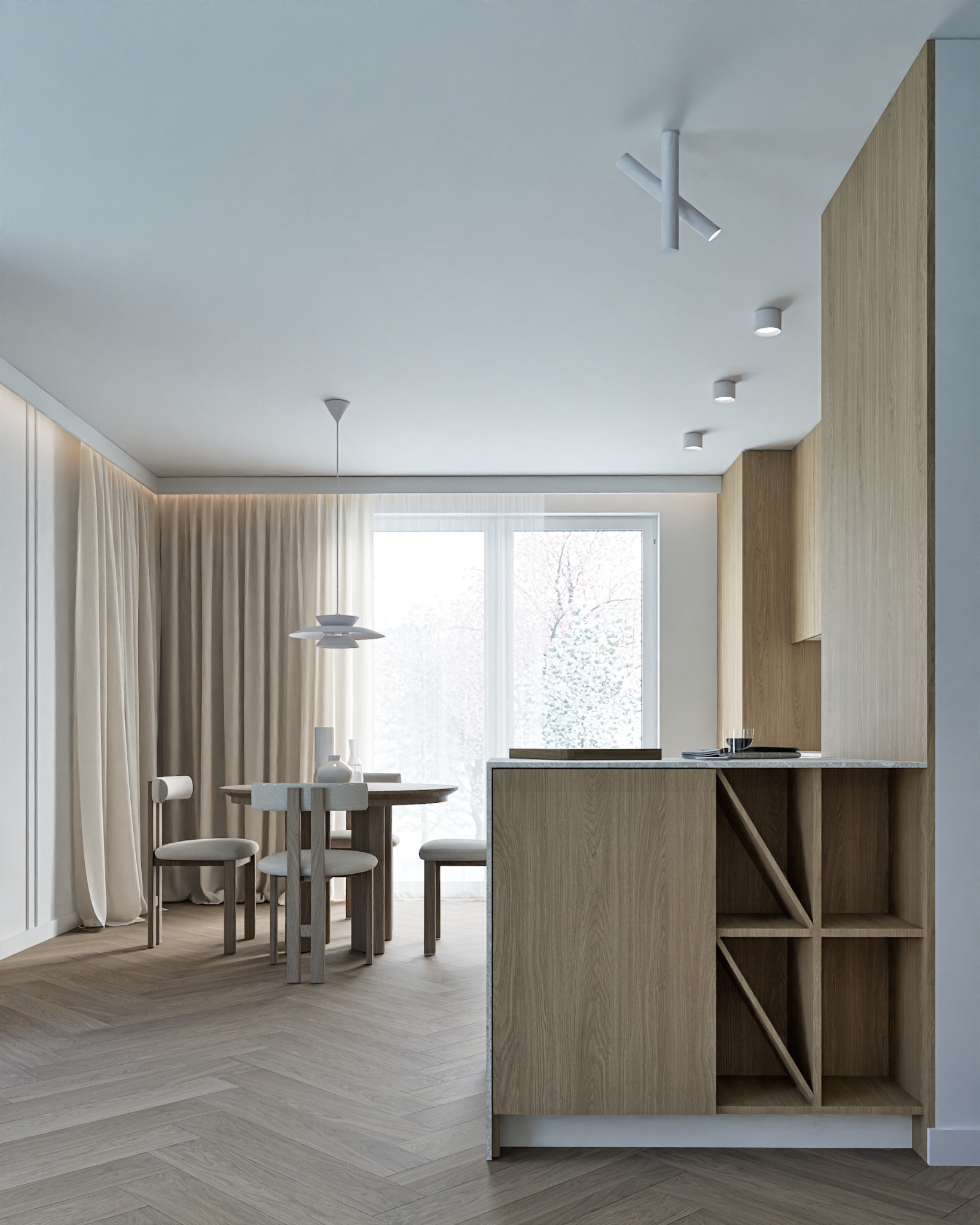 Jasne wnętrze: parkiet w jodełkę, stół z krzesłami, minimalistyczna lampa wisząca i zabudowa kuchenna z drewnianymi frontami. Nowoczesny design.