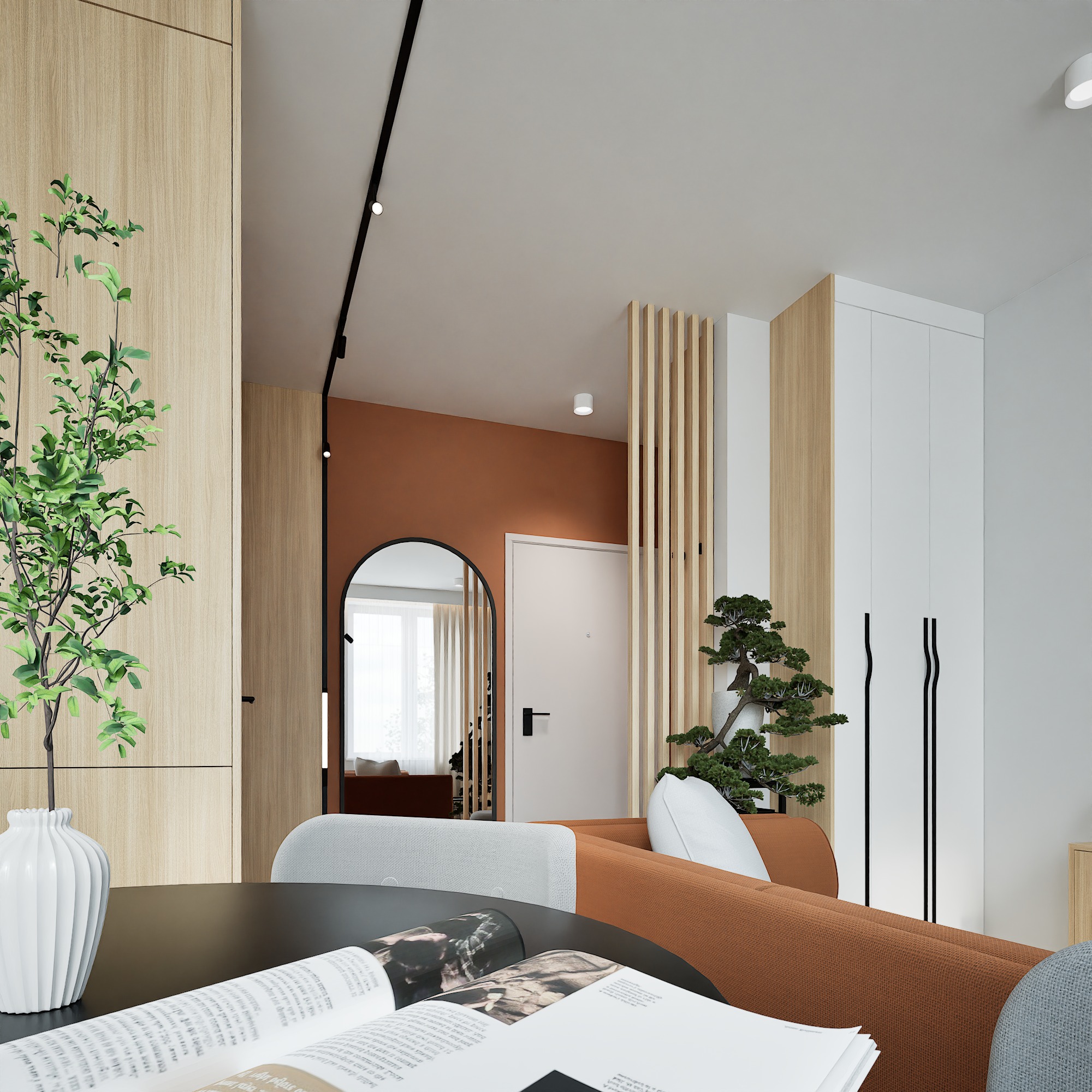 Nowoczesny salon z elementami drewna: okrągły stół z wazonem i książką, sofa w odcieniach brązu, lustro w czarnej ramie i dekoracyjne rośliny. Minimalistyczny design.