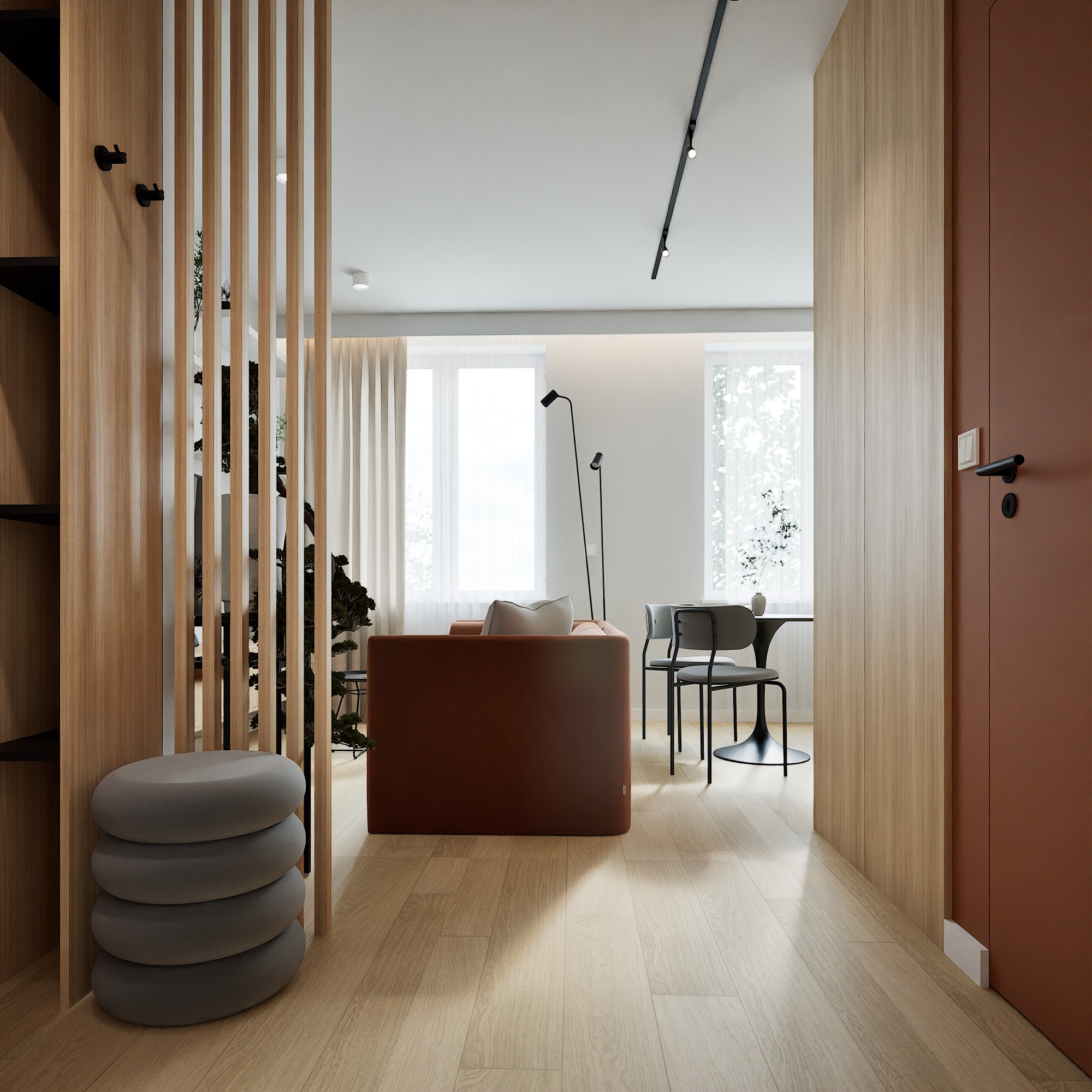 Nowoczesna aranżacja wnętrza z drewnianą ścianką działową i minimalistycznym wystrojem w Chorzowie. Widok na salon z sofą i jadalnią, jasne, naturalne światło.