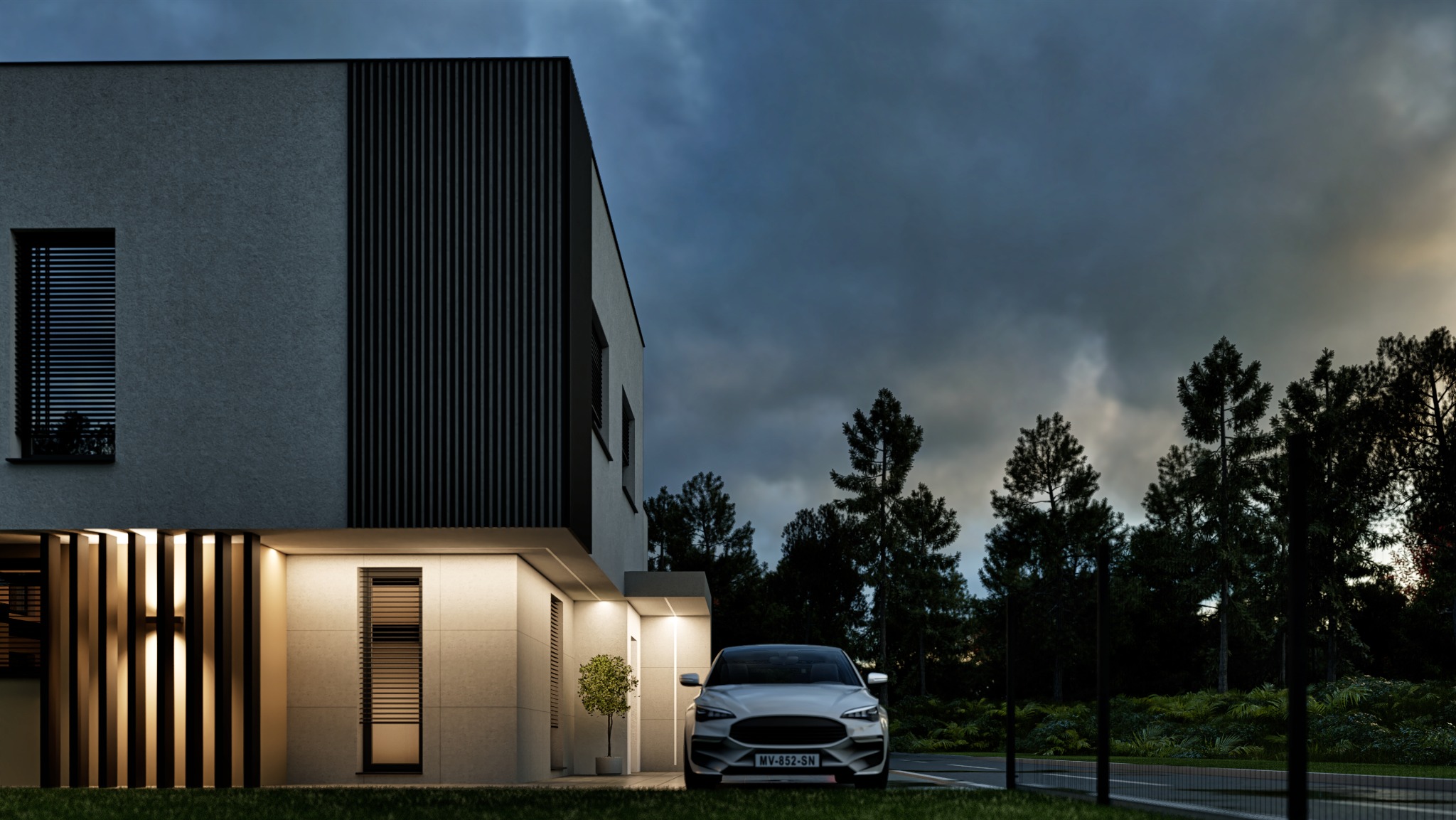Nowoczesny dom jednorodzinny z elementami drewna na elewacji, oświetlony ciepłym światłem, z samochodem zaparkowanym przed budynkiem na tle pochmurnego nieba.