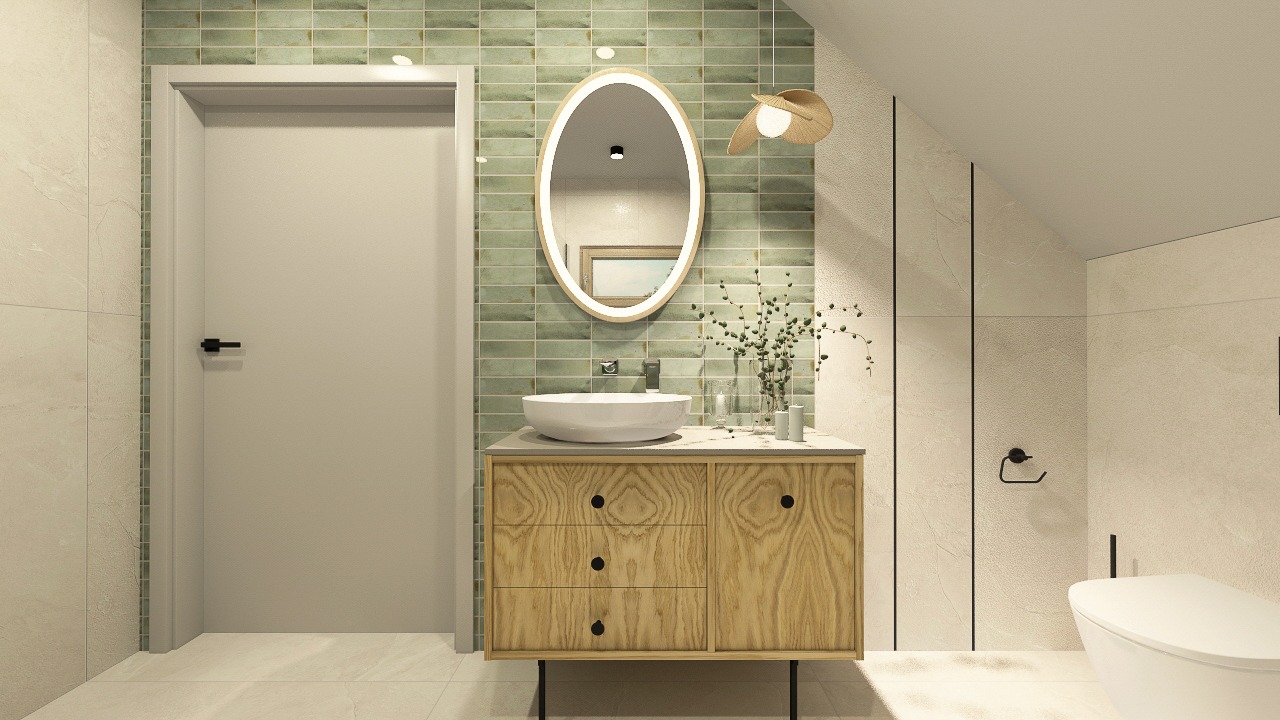 Jasna łazienka z umywalką nablatową na drewnianej szafce, owalnym lustrem z podświetleniem LED i zielonymi płytkami na ścianie. Minimalistyczny design.