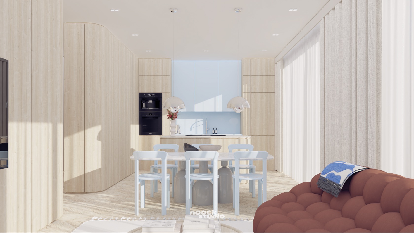 Jasne wnętrze z drewnianą zabudową, okrągłym stołem i pastelowymi krzesłami. Minimalistyczny design z akcentem na naturalne materiały i miękkie światło.