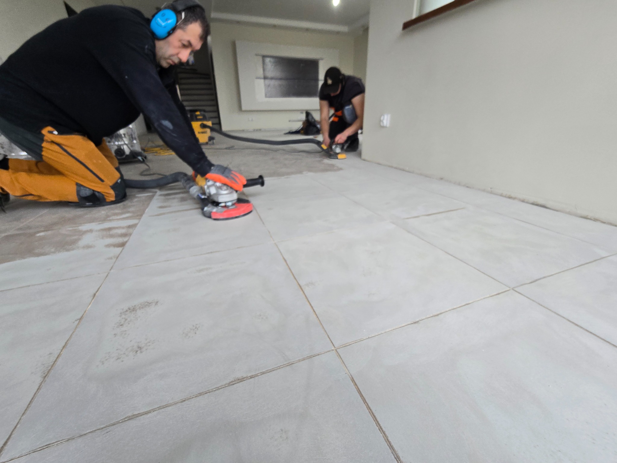 Szlifowanie starych płytek ceramicznych przed wylaniem żywicy ozdobnej.