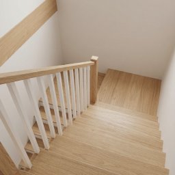 Twój Wymiar Pracownia Mebli - Jasne, drewniane schody z białą balustradą, widziane z góry. Naturalne oświetlenie podkreśla strukturę drewna i minimalistyczny design. Detal wykończenia.