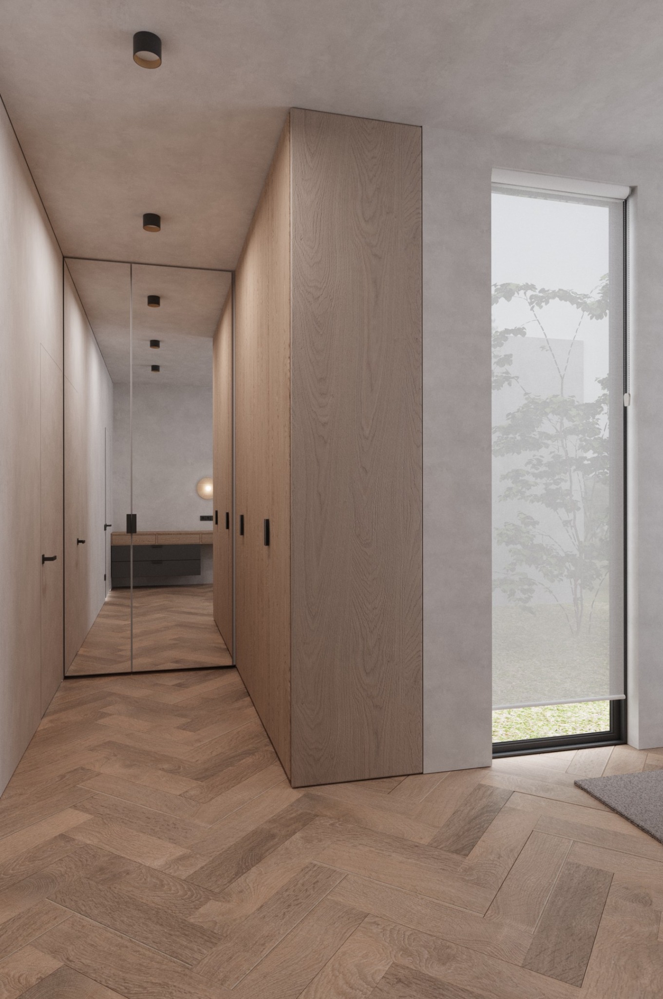 Minimalistyczny przedpokój z drewnianą podłogą w jodełkę, zabudową szaf z jasnego drewna i lustrem w czarnej ramie. Widok na zieleń za oknem.