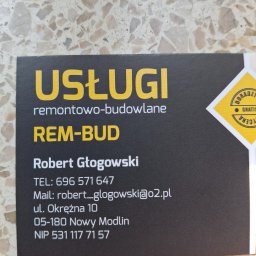 REM-BUD ROBERT GŁOGOWSKI - Wizytówka firmy REM-BUD Roberta Głogowskiego oferującej usługi remontowo-budowlane z numerem telefonu, adresem e-mail i NIP-em, leżąca na tle marmurowej posadzki.