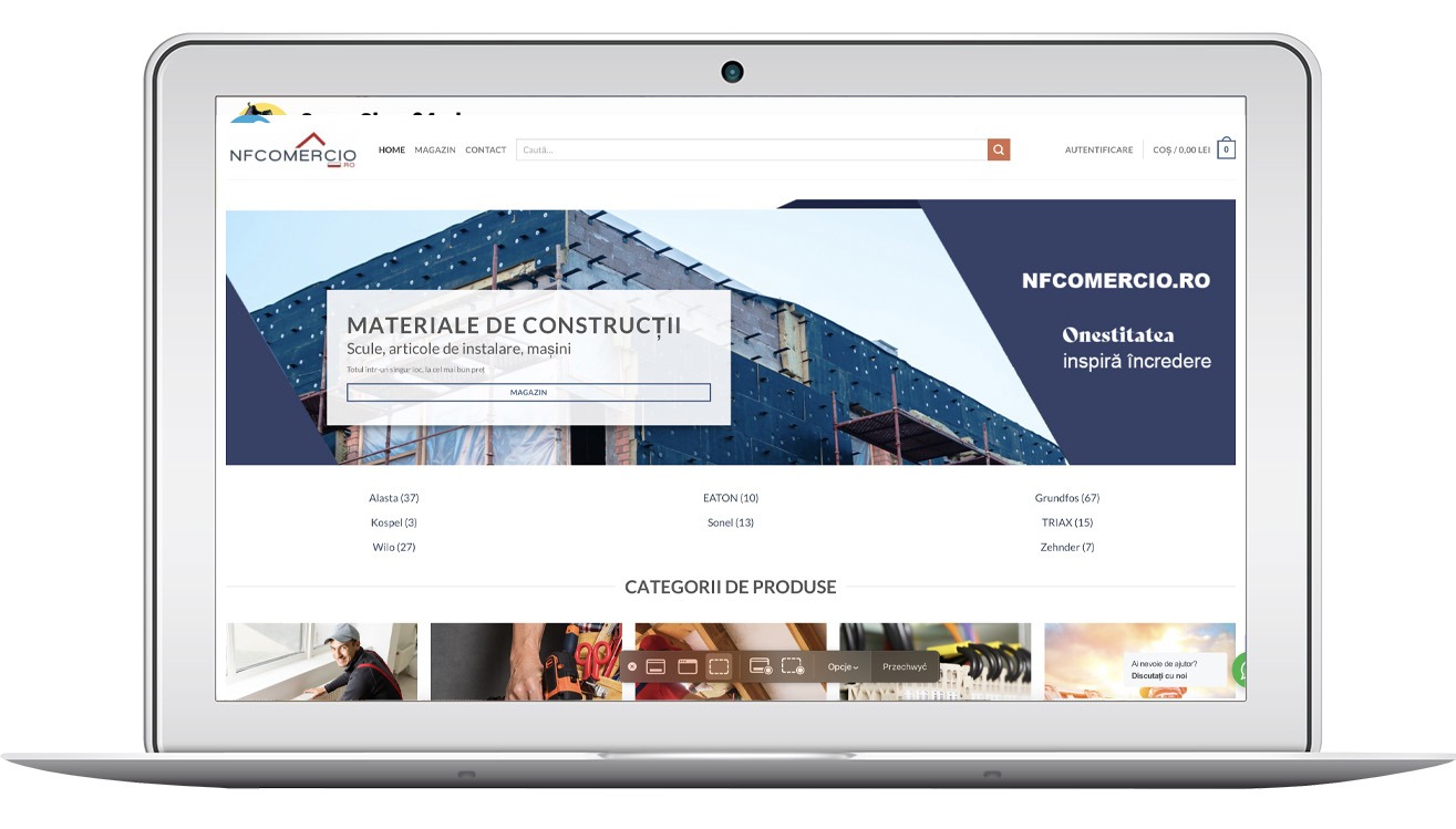 Laptop wyświetla stronę nfcomercio.ro z materiałami budowlanymi. Widoczne kategorie produktów i baner z hasłem 'Onestitatea inspiră încredere'.