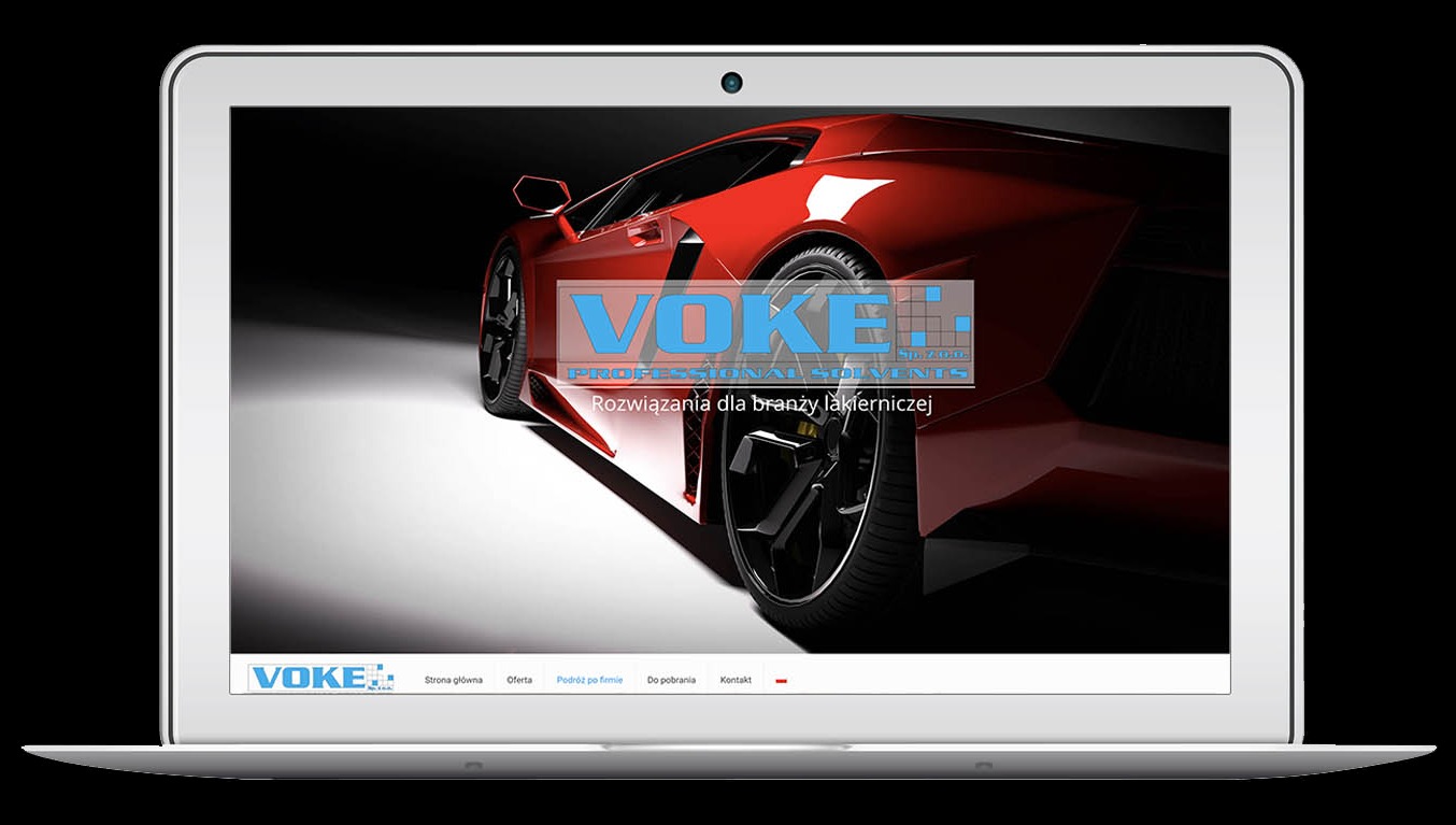 Laptop wyświetla stronę internetową Voke.pl z czerwonym sportowym samochodem w tle. Strona oferuje rozwiązania dla branży lakierniczej. Minimalistyczny design.