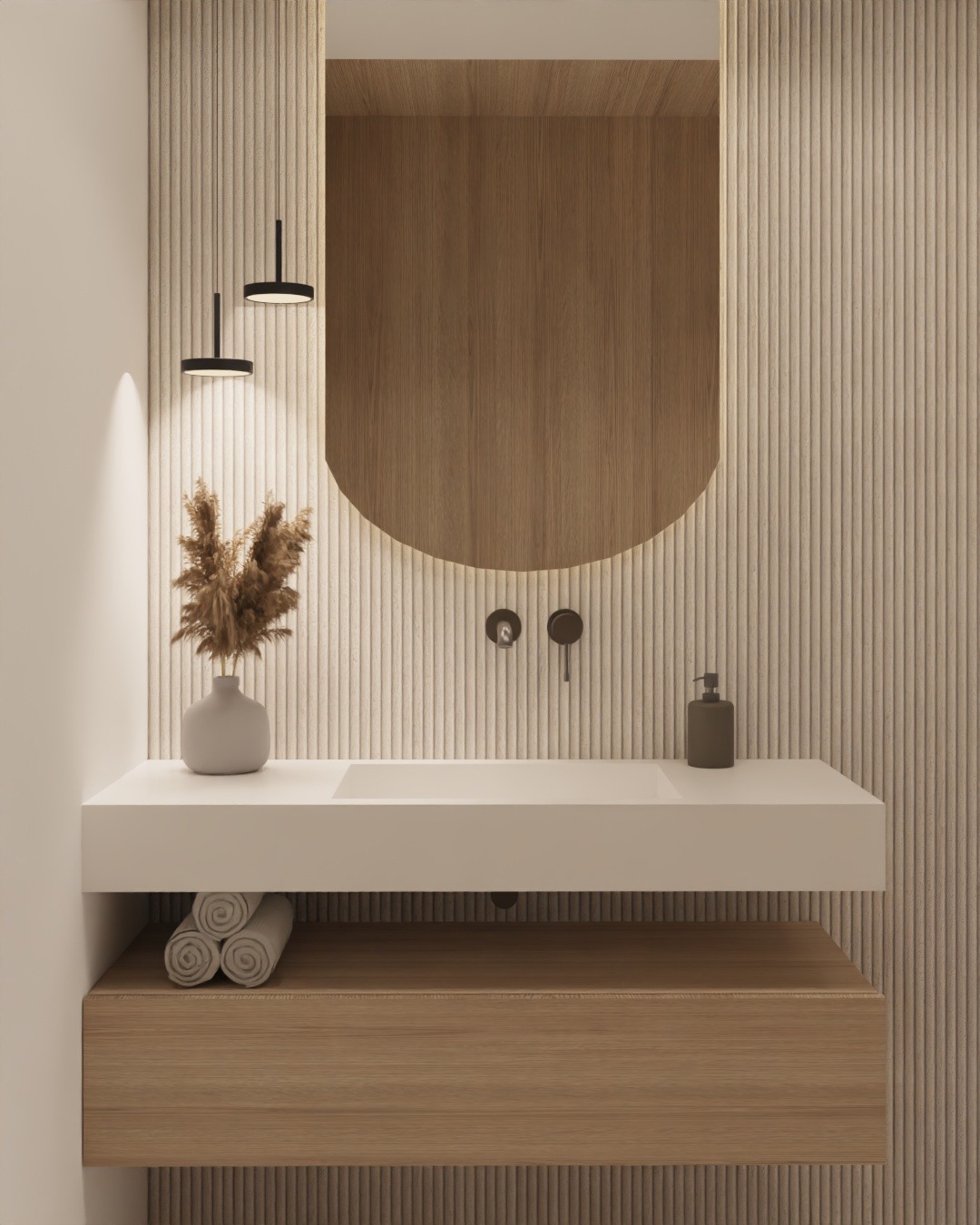 Nowoczesna łazienka z drewnianą zabudową umywalki, białym blatem i okrągłym lustrem. Minimalistyczne lampy wiszące i dekoracyjny wazon z suszem dodają elegancji.