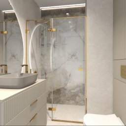 Studio Projektowania Wnętrz MONIKA STAWOWCZYK - Nowoczesna łazienka z dwoma umywalkami w odcieniach beżu i złota, kabina prysznicowa ze złotymi detalami, roślina w doniczce. Minimalistyczny design z marmurowym akcentem.