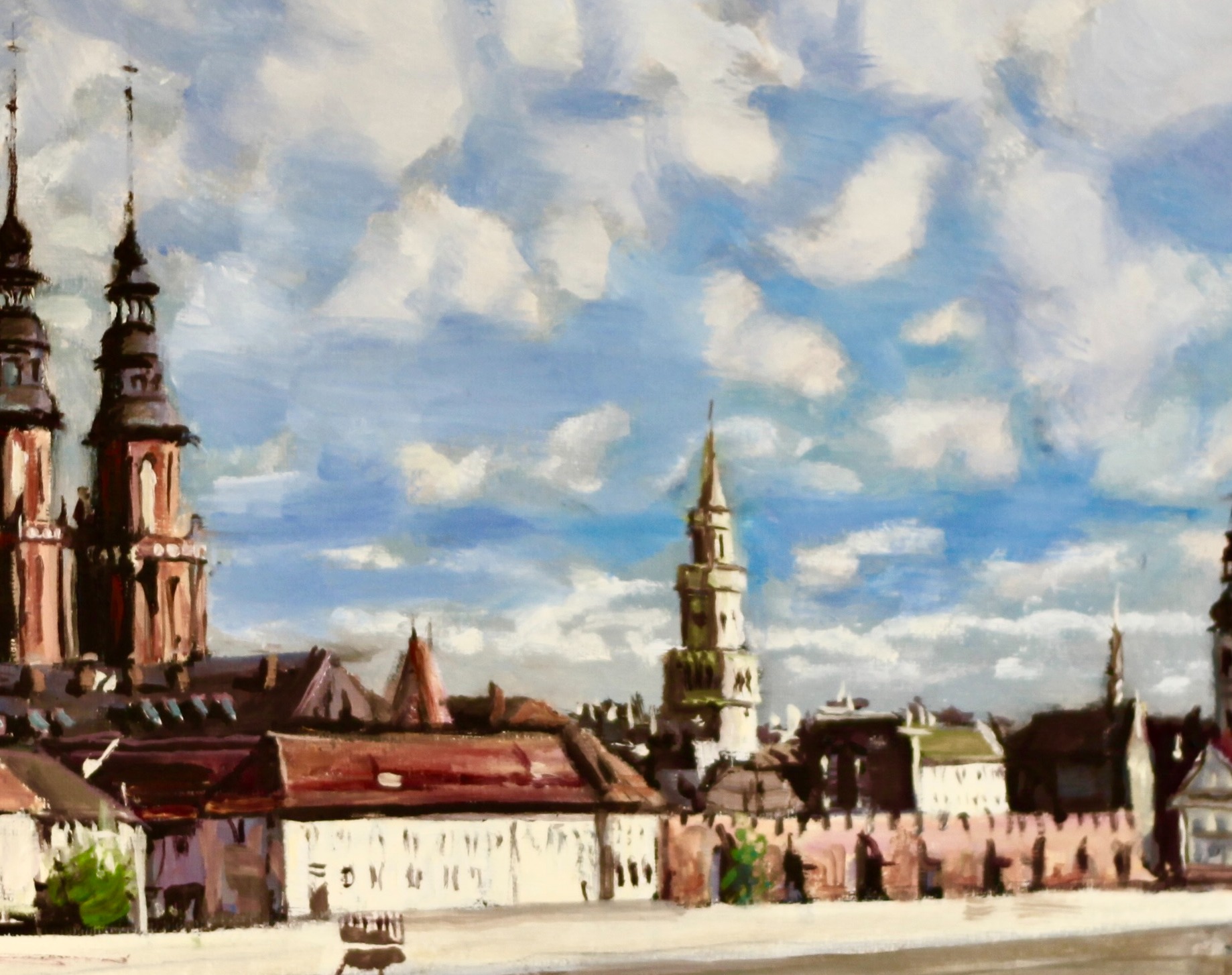 Pejzaż miejski w stylu impresjonistycznym: wieże kościołów, budynki z czerwonymi dachami i błękitne niebo z chmurami, namalowany grubymi pociągnięciami pędzla.