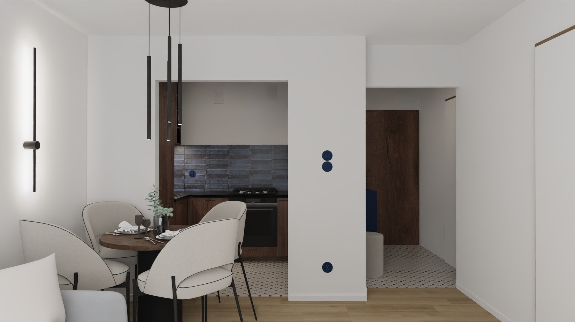 Wnętrze mieszkania z aneksem kuchennym, okrągłym stołem i krzesłami w stylu skandynawskim. Widoczne elementy dekoracyjne i oświetlenie.