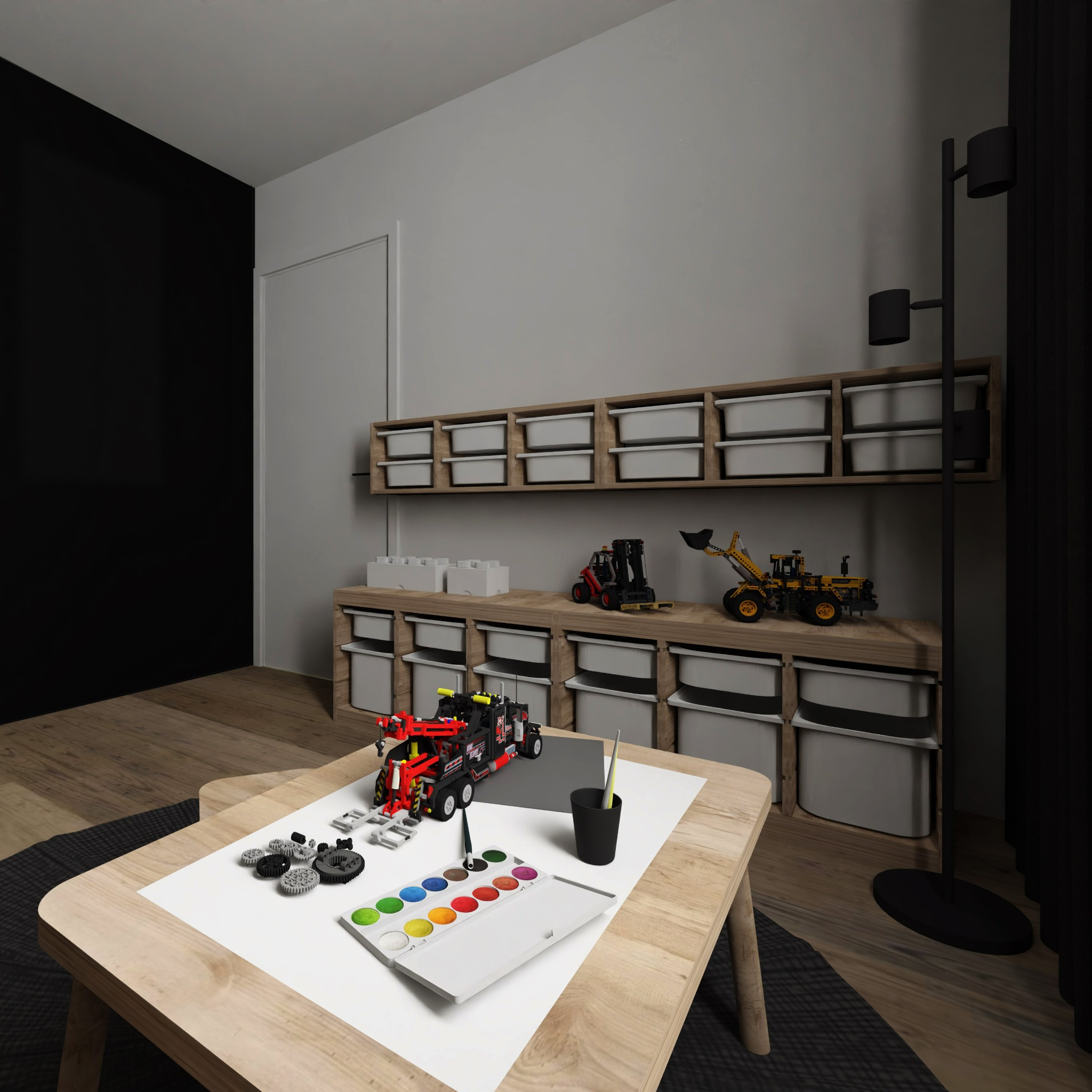 Pokój dziecięcy z drewnianym biurkiem, na którym leżą klocki, farby i pędzel. W tle regał z pojemnikami na zabawki i czarna ściana.