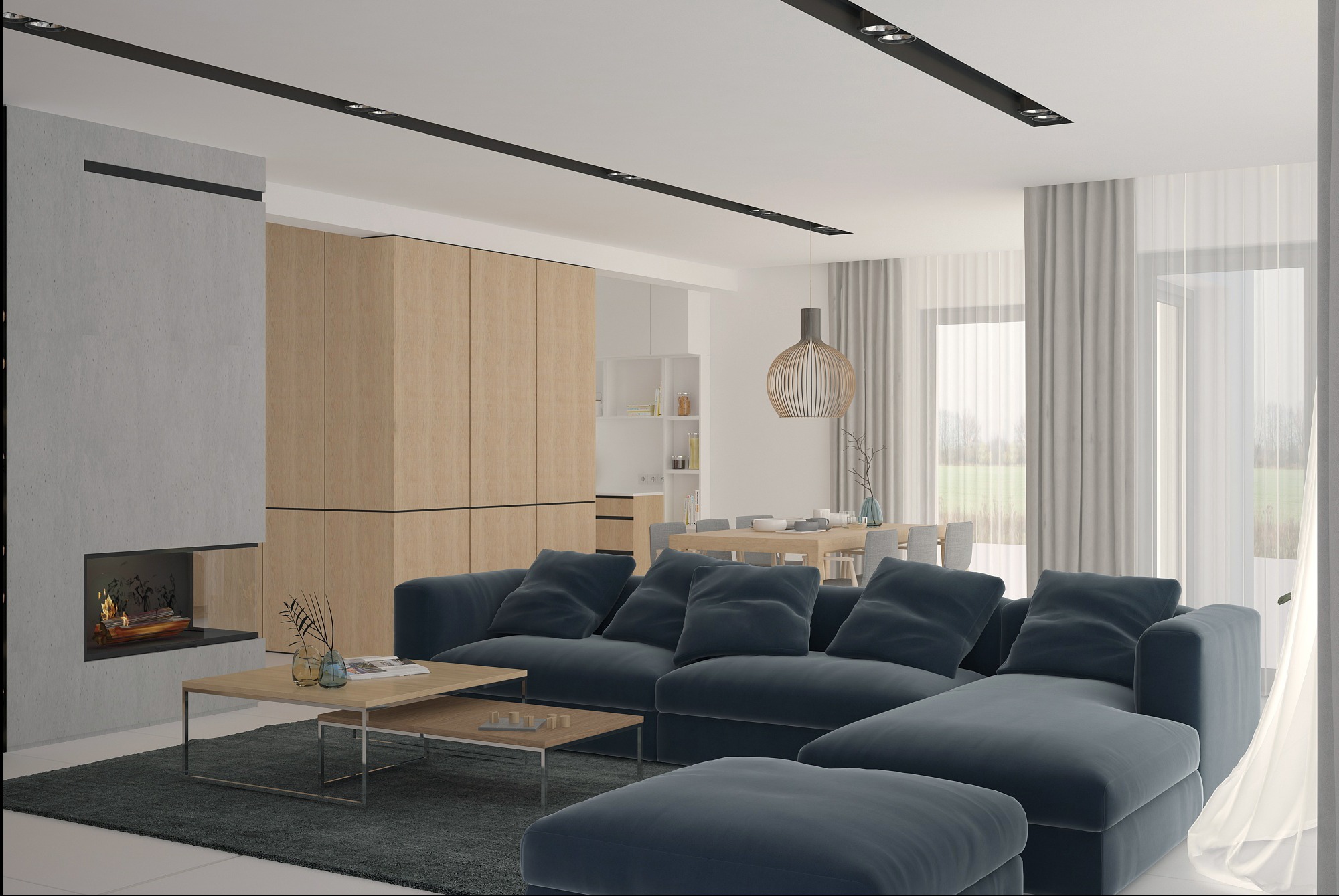 Nowoczesny salon z narożną sofą w odcieniach granatu, minimalistycznym kominkiem i drewnianymi szafkami. W tle jadalnia z drewnianym stołem i krzesłami.