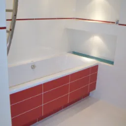 Nowoczesna łazienka z wanną obudowaną czerwonymi płytkami, oświetlonymi wnękami w ścianie i drabinką na ręczniki.