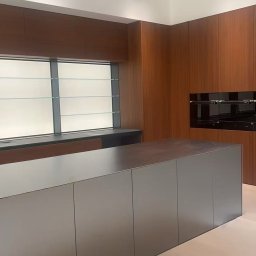 Meble na wymiar wraz z wyspą wykonaną ze stali.