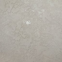 Sylwester Bieniecki - Szara ściana z wyraźną, nieregularną fakturą. Widoczne drobne nierówności i delikatne cieniowanie, tworzące efekt trójwymiarowości. Neutralna kolorystyka.