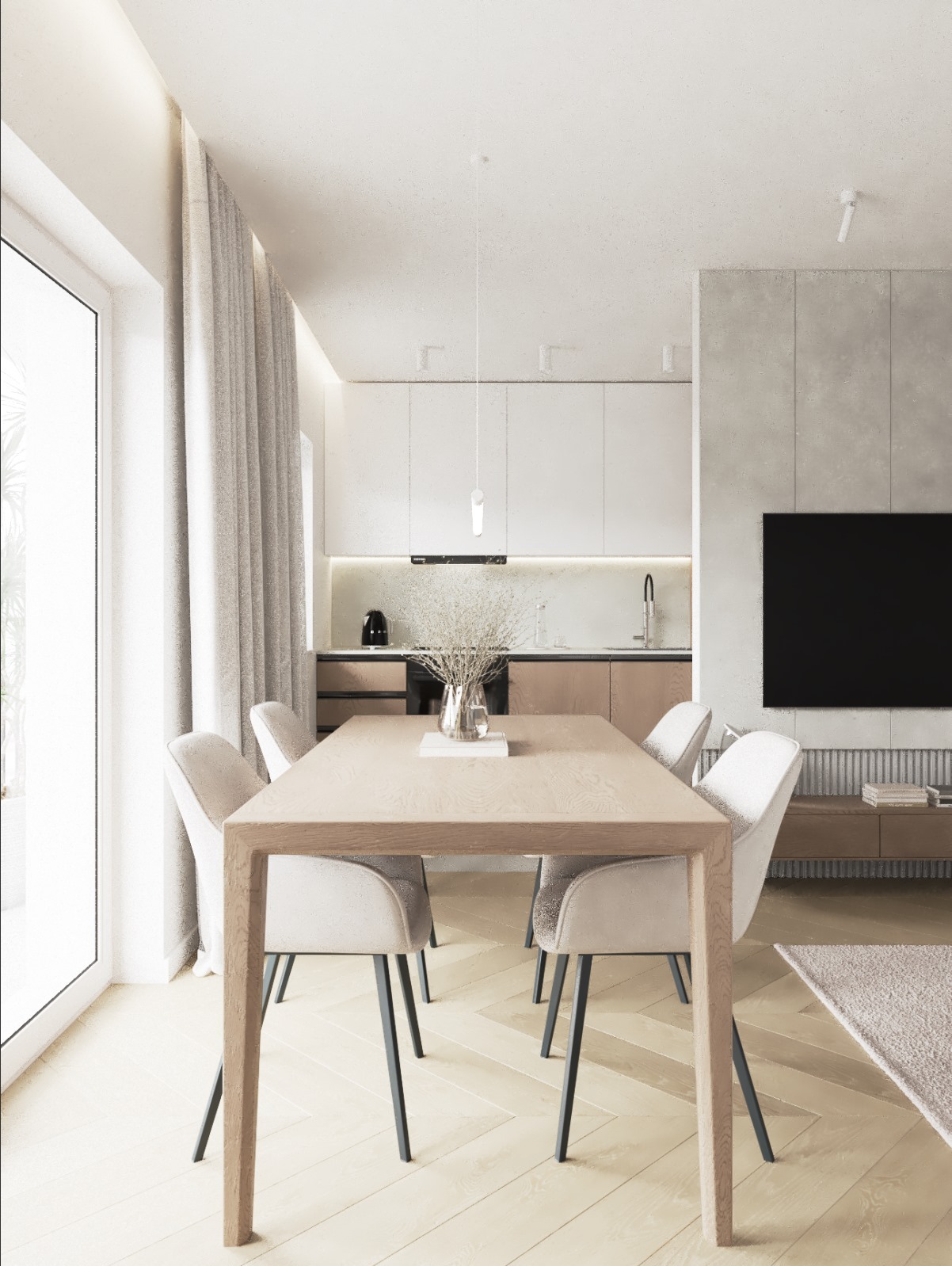 Jasna jadalnia z drewnianym stołem i krzesłami w stylu skandynawskim. W tle widoczna kuchnia z białymi szafkami i telewizor na ścianie.