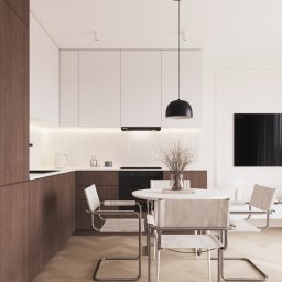 Neuform - Nowoczesna kuchnia z drewnianymi i białymi szafkami, okrągłym stołem i krzesłami w stylu Bauhaus, oświetlona wiszącą lampą. Parkiet w jodełkę.